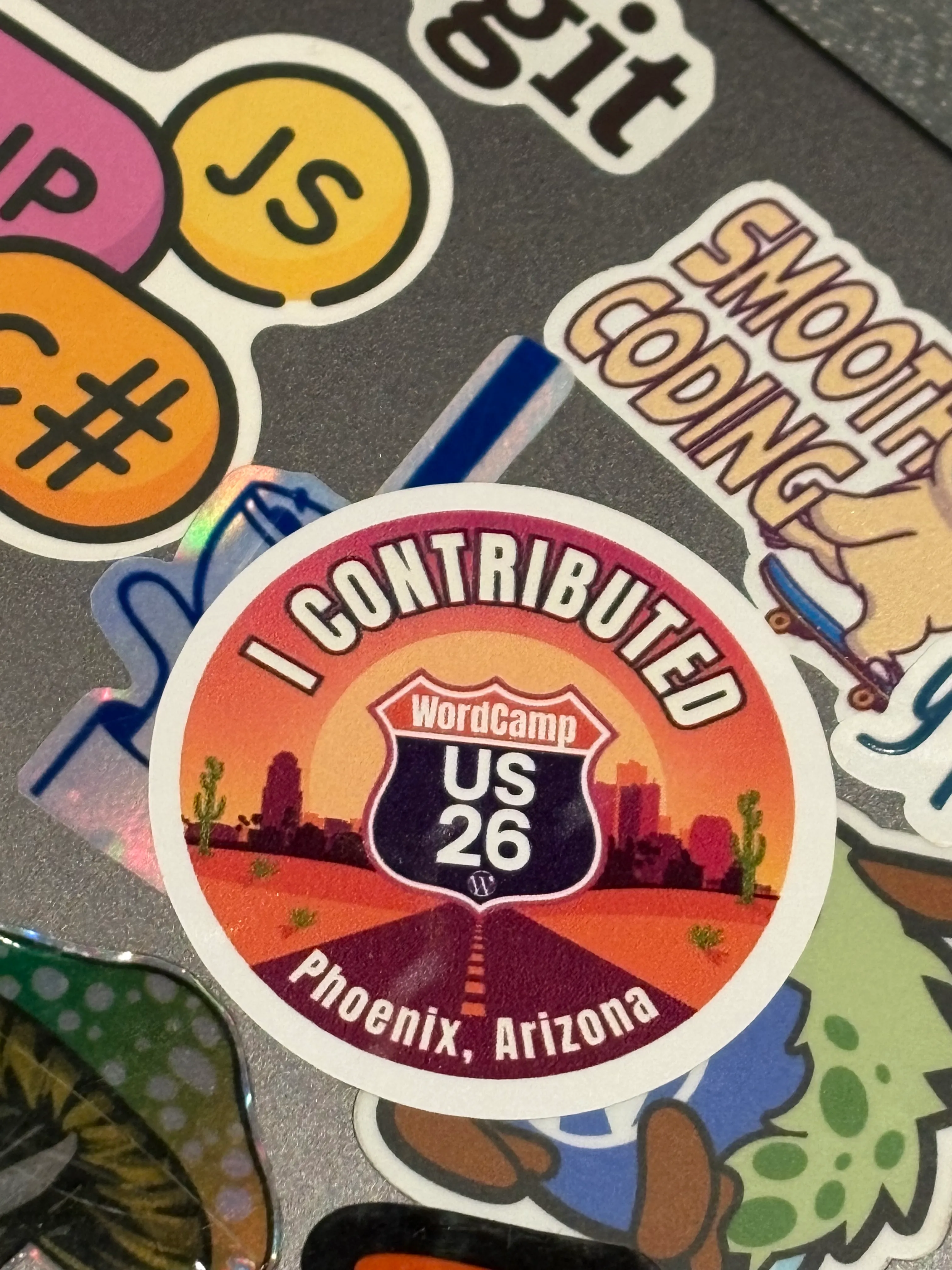 Close-up of an “I Contributed” WordCamp US 2026 sticker from Phoenix.
