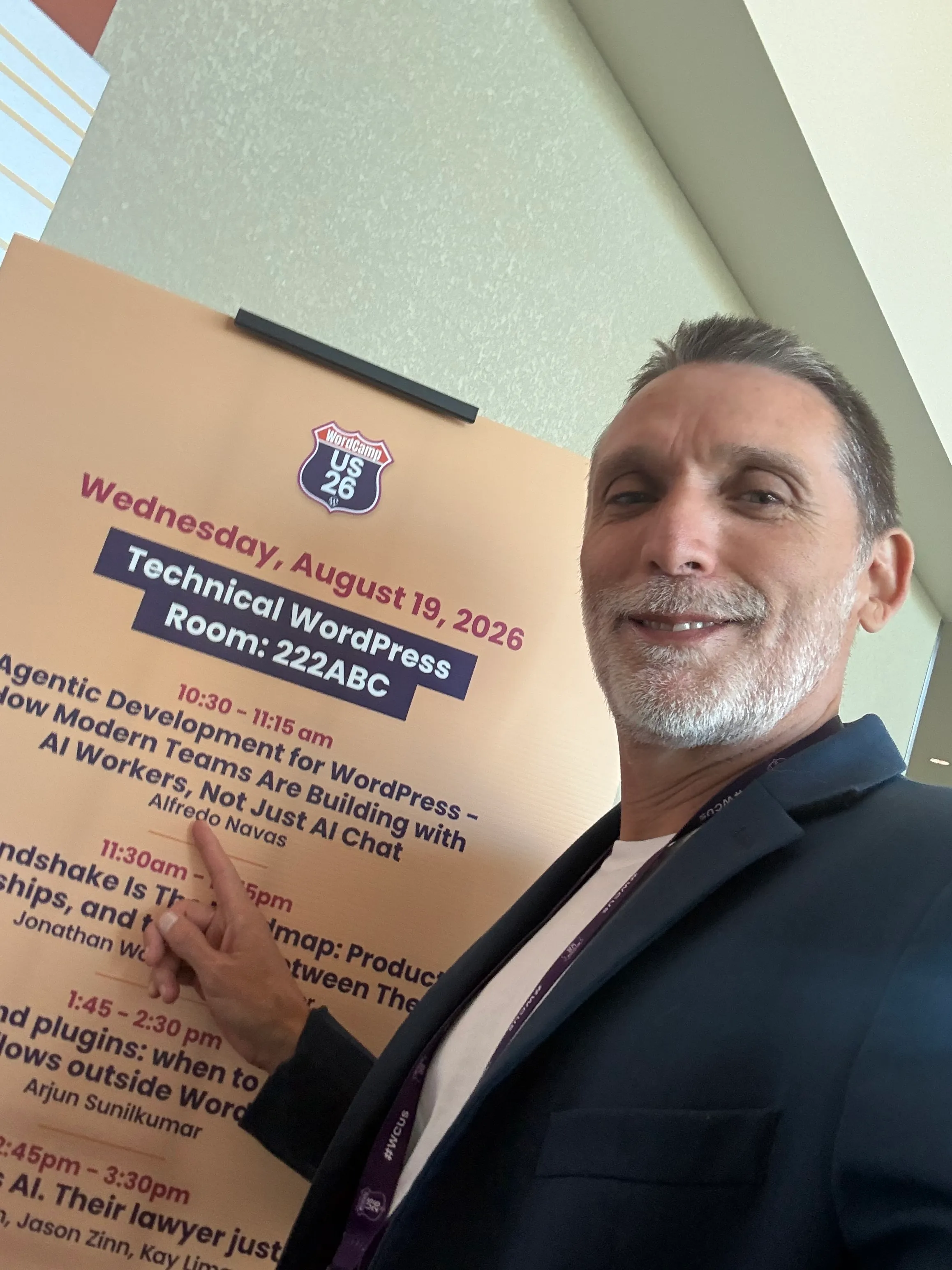Alfredo Navas smiling and pointing to his Agentic Development session on the WordCamp US 2026 schedule.